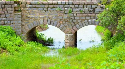 Old stone single arch bridge, Latvia. Famous ancient stone arch single track Stock Photos