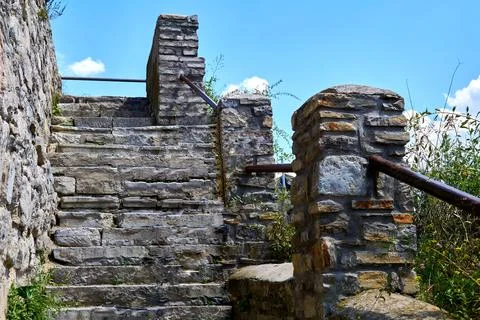 Old stone staircase with railing on the background of the sky Stock Photos
