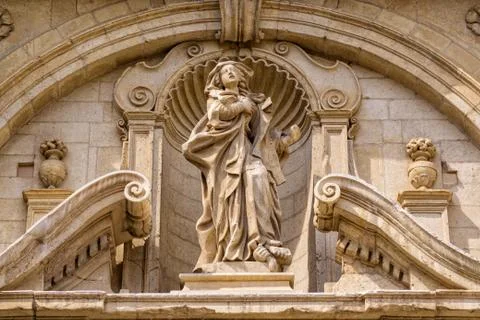 Old stone statue on a building facade in Italy Stock Photos