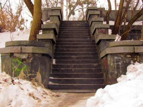 Old stone steps on the bridge over the river Stock Photos