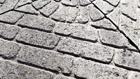 Old stone tiled floor with round pattern on a sunny street Stock Footage 117608944