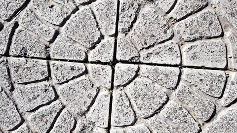 Old stone tiled floor with round pattern on a sunny street Stock Footage 117609200