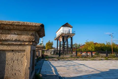 An old stone tower on the square with a park Stock Photos