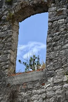 Old Stone Wall Arch Window Opening with Blue Sky View Stock Photos