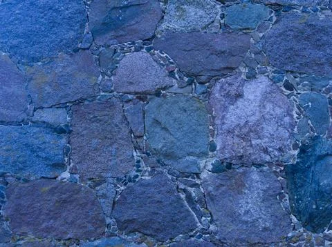 An old stone wall. Background of blue stones. The texture of the stone. Mason Stock Photos