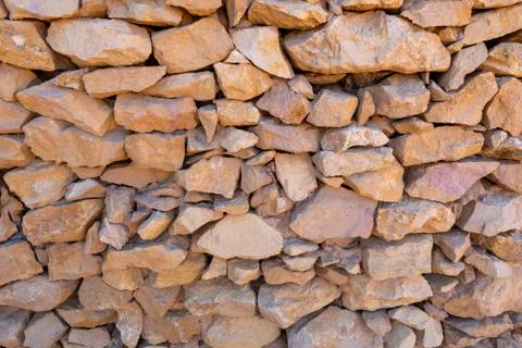 Old stone wall background pattern, constructed with natural rocks Stock Photos
