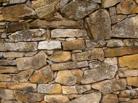 Old stone wall beautiful composition of different shapes Stock Photos