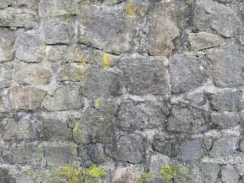 Old stone wall with different size of rocks Stock Photos