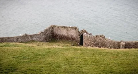 Old stone wall in front of the sea Stock Photos