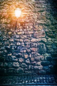 Old stone wall with lantern Stock Photos