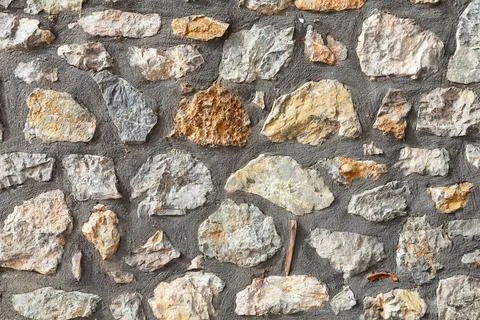 Old stone wall made of large gray natural stones. Stone wall rustic texture.. Stock Photos
