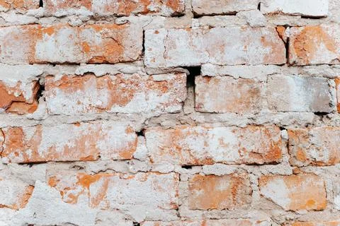 Old stone wall made of red dirty bricks, close-up. Rough texture background Stock Photos