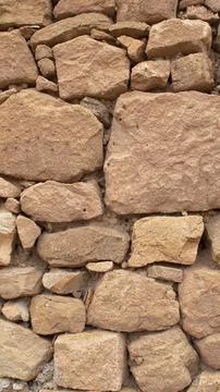 Old stone wall made without cement between the stones Stock Photos