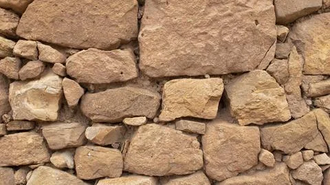 Old stone wall made without cement between the stones Stock Photos