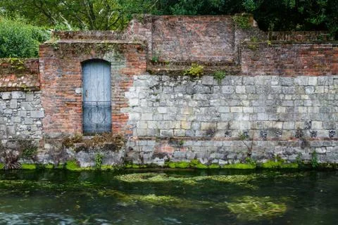 Old stone wall on river Stock Photos