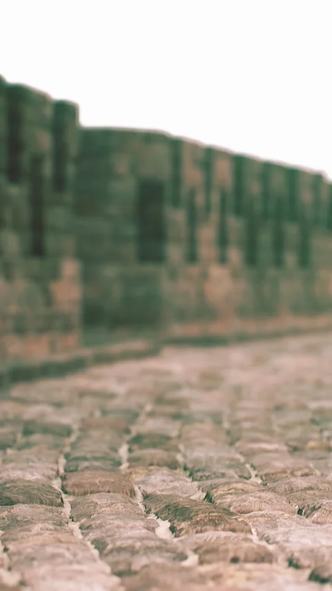 Old stone wall seen in focus with cobblestone path at historical site Stock Footage 346758308