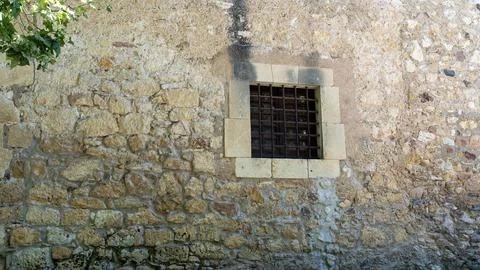 Old Stone Wall with Small Barred Window Stock Photos