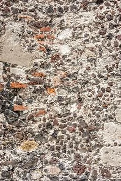 Old stone wall surface with textured plaster and brick Fotos de archivo