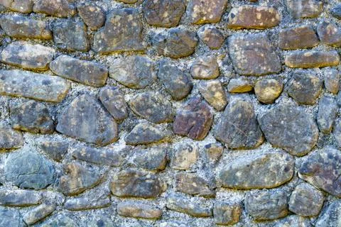 Old stone wall texture background. Close up shot. High resolution Stock Photos