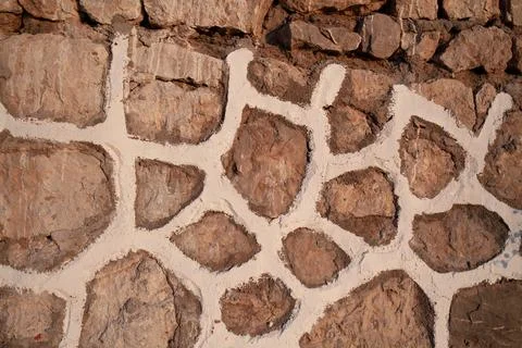 Old stone wall texture background. Rough stone wall. Big rough stones fence Stock Photos
