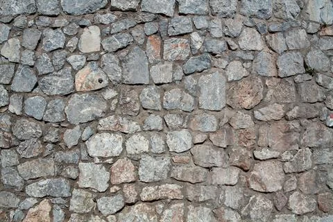 Old stone wall texture background. Rough stone wall. Big rough stones fence Foto stock