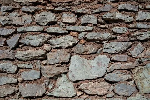 Old stone wall texture background. Rough stone wall. Big rough stones fence Stock Photos