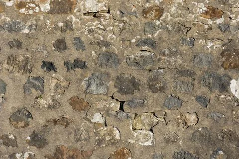 Old stone wall texture with weathered sandstone blocks with cement mortar Stock Photos