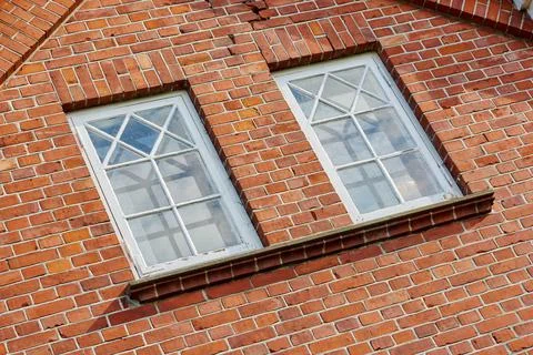 Old stone wall with two rectangular windows. Close up of rectangular windows of Stock Photos