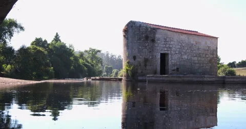 Old stone water mill on River Ave in rural Portugal, on a summer afternoon Video stock 134503459