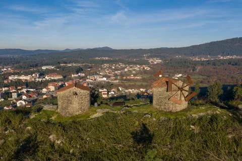 Old stone windmill on a hill in the light of sunset Stock Photos