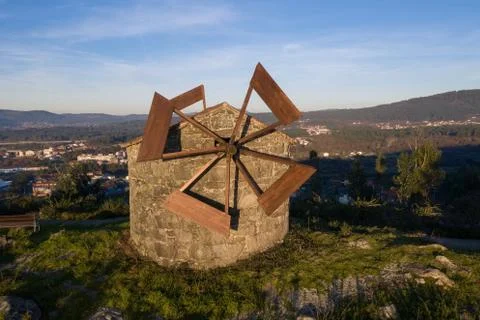 Old stone windmill on a hill in the light of sunset Foto stock