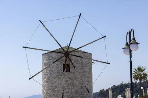 Old stone windmill standing under a clear blue sky on Corfu island Stock Photos
