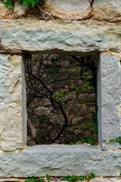 Old stone window frame on abandoned house Stock Photos
