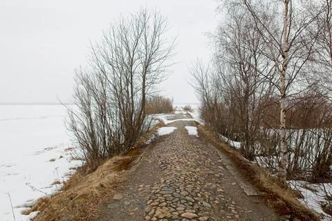 Old stony path to pier. Stock Photos