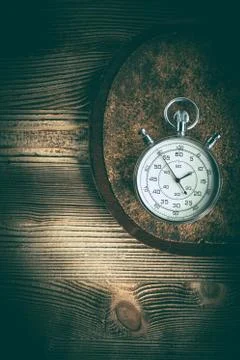 An old stopwatch on a cork background. Stock Photos