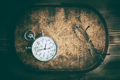 An old stopwatch on a cork background. Stock Photos