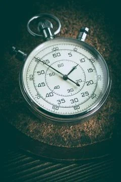 An old stopwatch on a cork background. Stock Photos