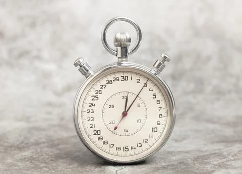 Old stopwatch on a gray background Stock Photos