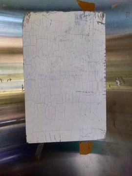 Old strached small White board on silver metallic wall background Stock Photos