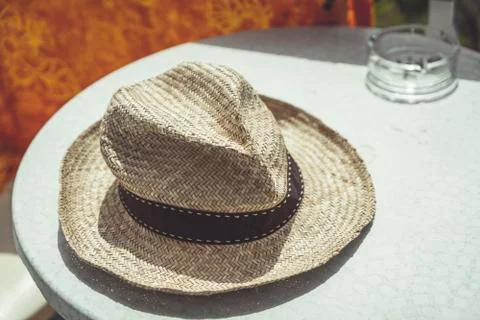Old straw hat on a table Stock Photos