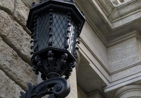 Old street lamp in center of Prague. On an old building made of marble Stock Photos