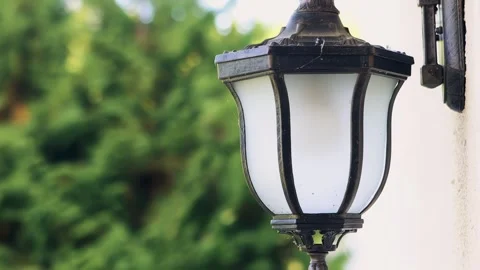 An old street lamp, a lantern on the wall of a house Stock Footage 260881025