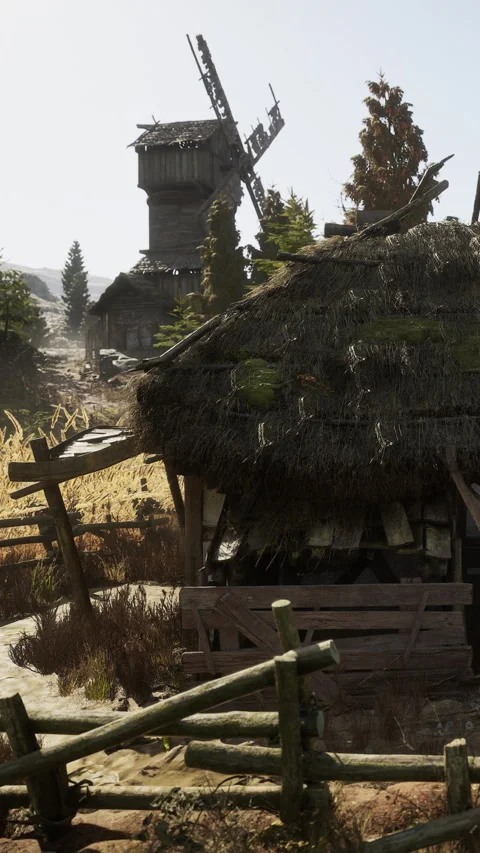 Old structure and windmill in a rural area during daytime Stock Footage 337892937