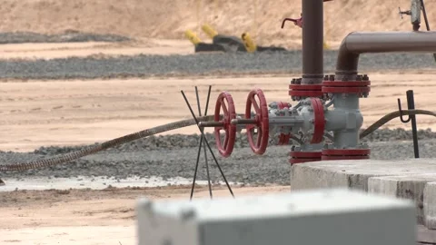Old structure of the oil wellhead with pipe fittings, valves Stock Footage 328456607