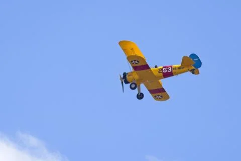 Old style biplane in the sky. Stock Photos