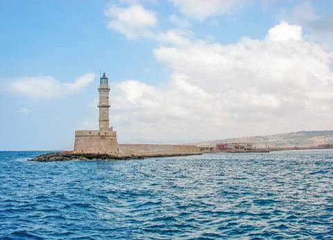 Old Style Brick made Lighthouse rising from a pier in the middle of the deep Fotos de archivo