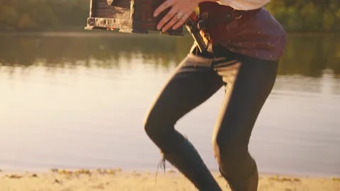 Old style brown chest stands on sand river bank lake sea. Treasure chest wooden Stock Footage 311985602