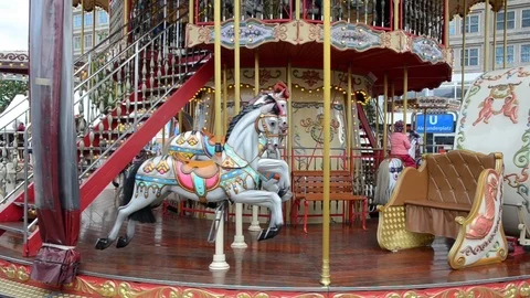 Old style carousel moving on square in Berlin. Traditional Venetian Carousel Video stock 111219117