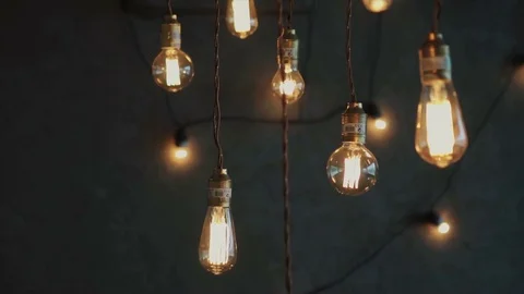 Old style glowing tungsten light bulbs, luxury lighting vintage decor Stock Footage 70425652