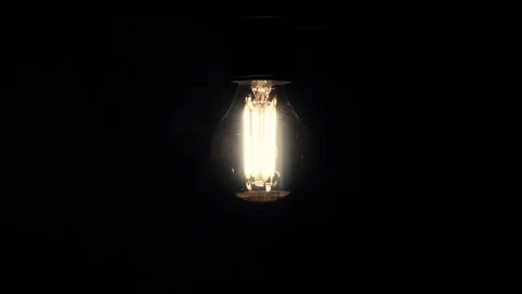 Old style lamp blinking over black background, macro shot. Slow motion Stock Footage 105469533